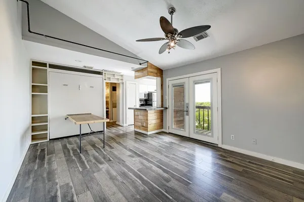 a view of a livingroom with a hardwood floor and a ceiling fan
