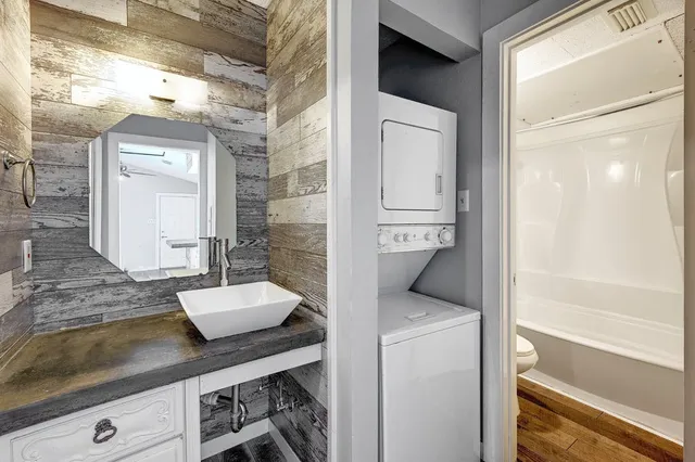 a en suite bathroom with a granite countertop sink and a mirror