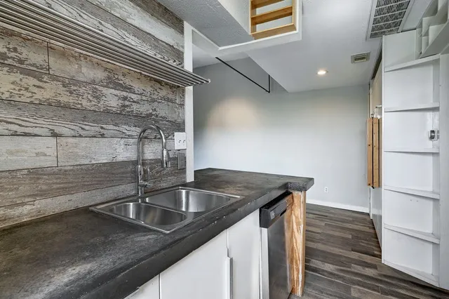 a kitchen with a sink and cabinets