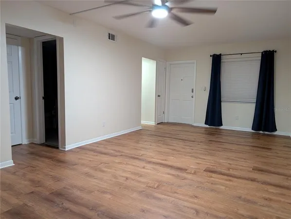 a view of walk in closet with wooden floor
