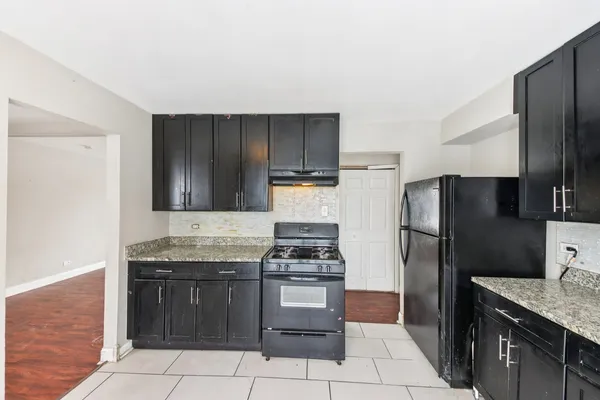 a kitchen with granite countertop stainless steel appliances and a refrigerator