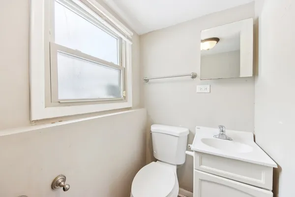 a white toilet sitting next to a bathroom sink