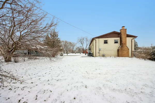 a view of a house with snow on the road