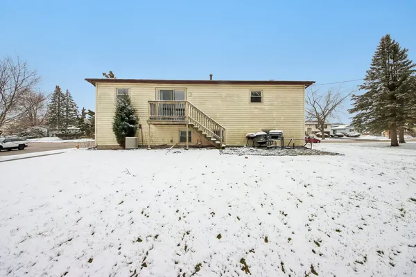 a backyard of a house with snow in front of it
