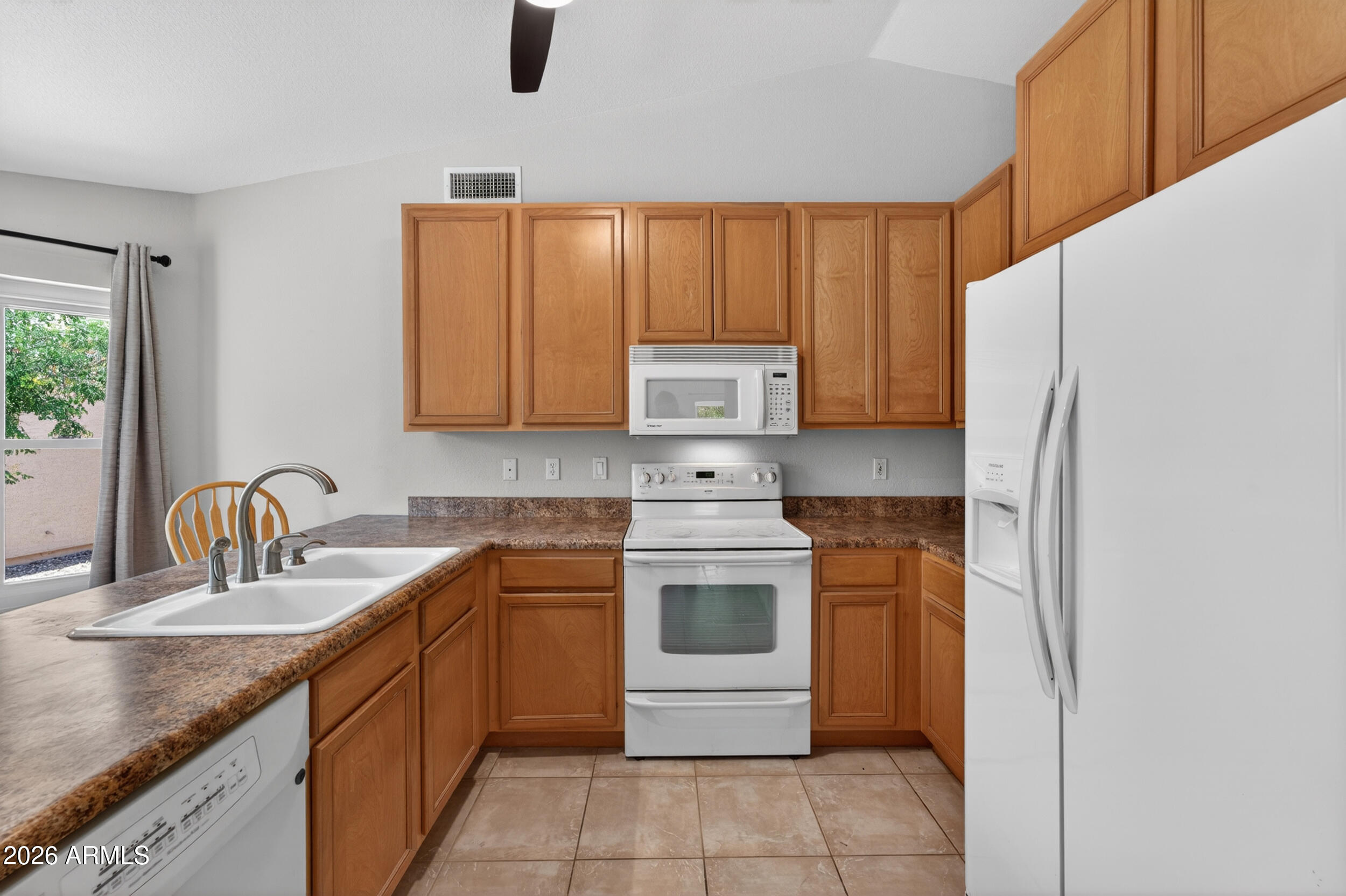 4729 West Monterey Street Chandler, AZ 85226 - Photo 17 of 50 a kitchen with stainless steel appliances granite countertop a sink stove and refrigerator