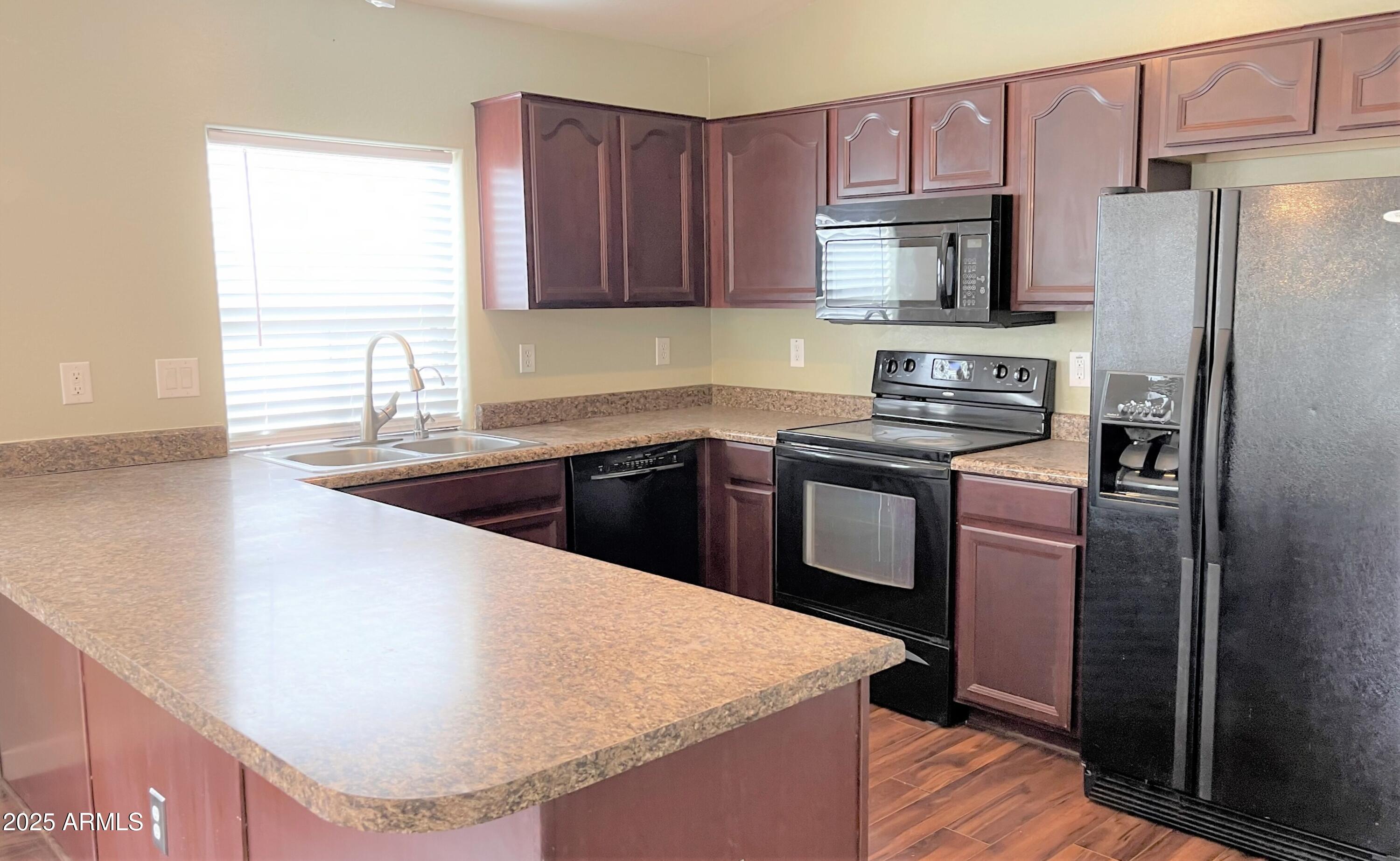 3984 East Tanzanite Lane San Tan Valley, AZ 85143 - Photo 4 of 20 a kitchen with stainless steel appliances granite countertop a sink stove and refrigerator