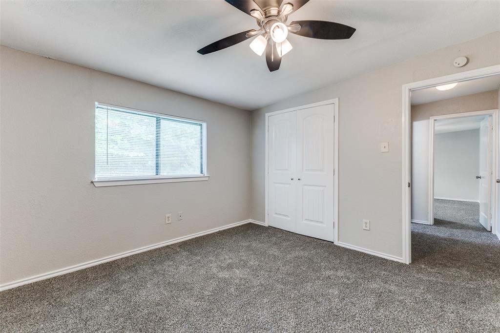 12129 Spring Branch Drive Balch Springs, TX 75180 - Photo 5 of 11 Unfurnished bedroom with dark carpet, a closet, and ceiling fan