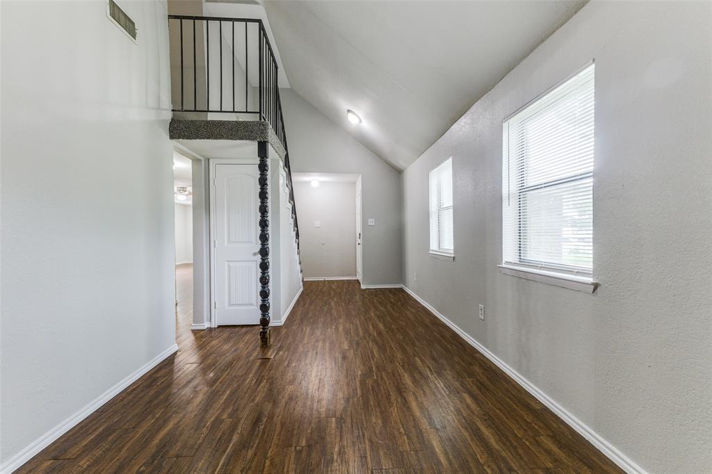 12129 Spring Branch Drive Balch Springs, TX 75180 - Photo 7 of 11 Entryway with vaulted ceiling and dark wood-type flooring