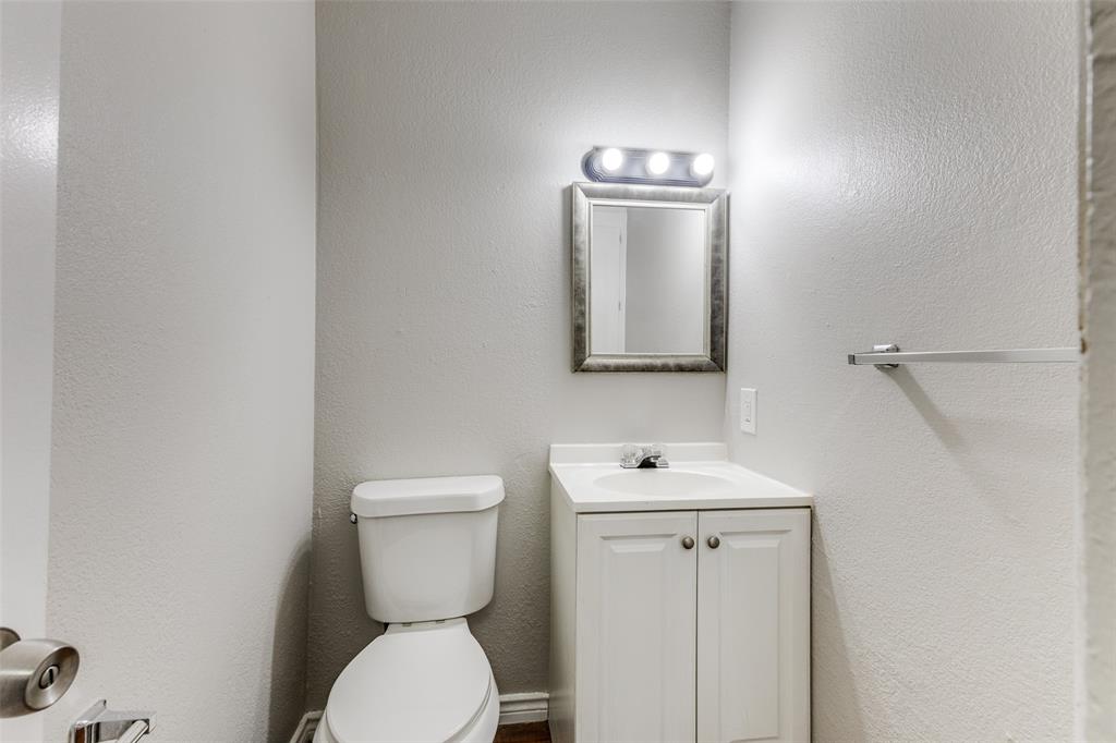 12129 Spring Branch Drive Balch Springs, TX 75180 - Photo 9 of 11 Half bath featuring vanity and a textured wall