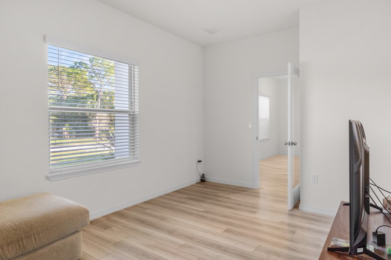 1014 Guava Street Sebastian, FL 32958 - Photo 12 of 30 a view of empty room with wooden floor and fan