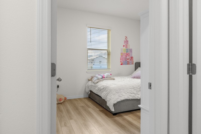 1014 Guava Street Sebastian, FL 32958 - Photo 22 of 30 a bedroom with a bed and wooden floor