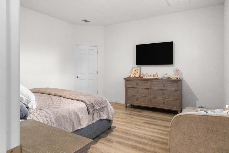 1014 Guava Street Sebastian, FL 32958 - Photo 24 of 30 a bedroom with a bed and a flat screen tv