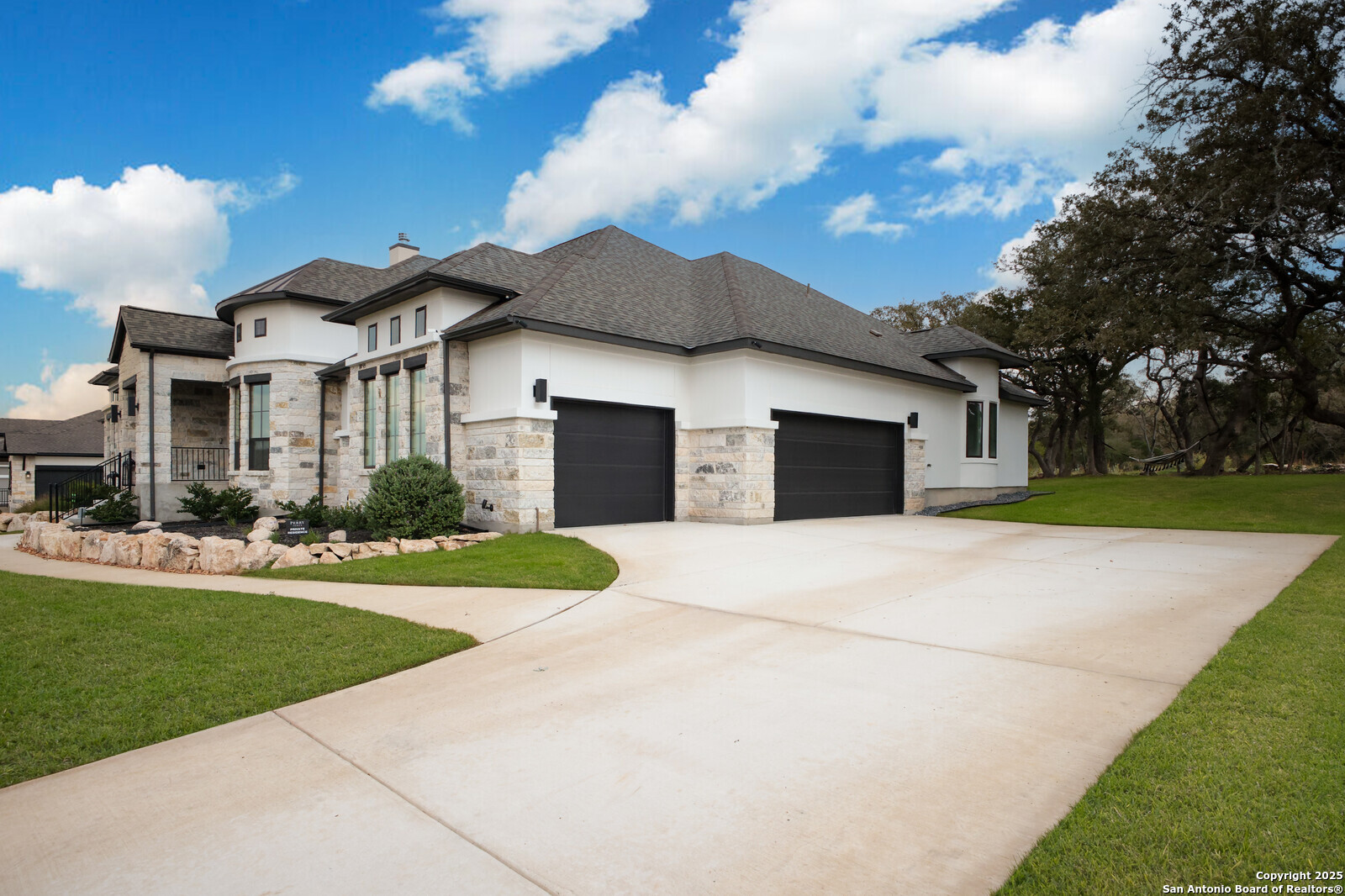a front view of a house with a yard and garage