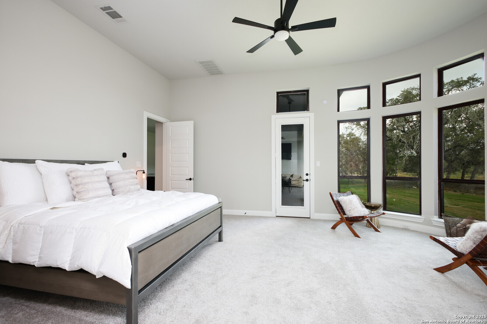 431 Falcon Cove Castroville, TX 78009 - Photo 17 of 46 a living room with a bed furniture and a large window