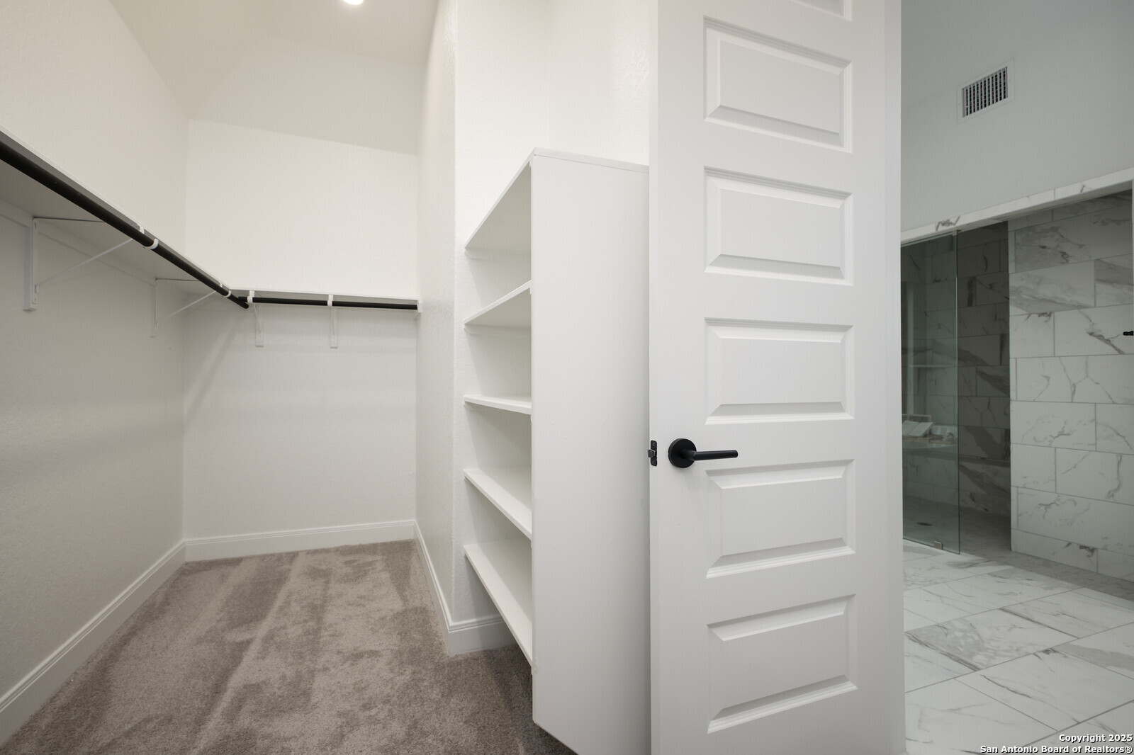 431 Falcon Cove Castroville, TX 78009 - Photo 22 of 46 a view of walk in closet with empty racks