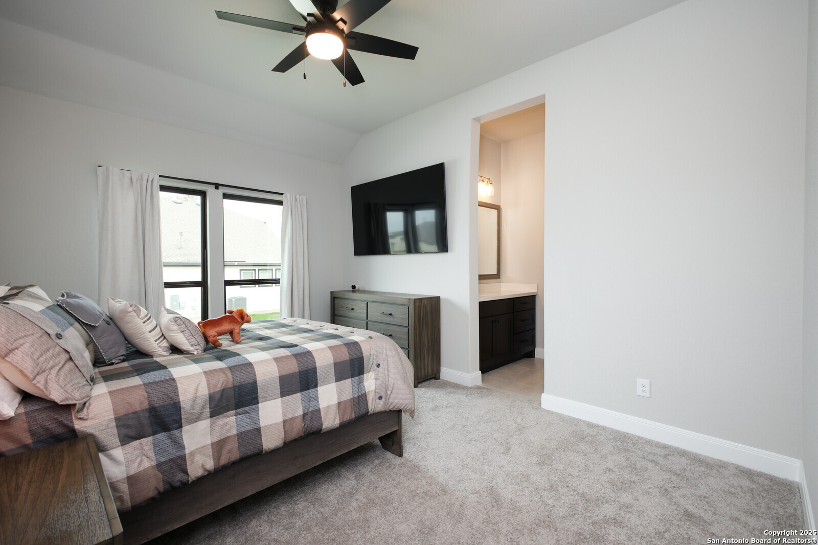 431 Falcon Cove Castroville, TX 78009 - Photo 24 of 46 a bedroom with a bed a fireplace and a window