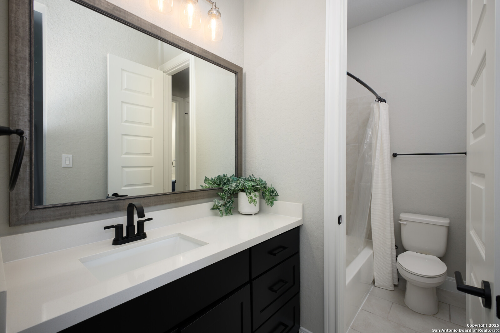 431 Falcon Cove Castroville, TX 78009 - Photo 25 of 46 a bathroom with a sink a toilet and a mirror
