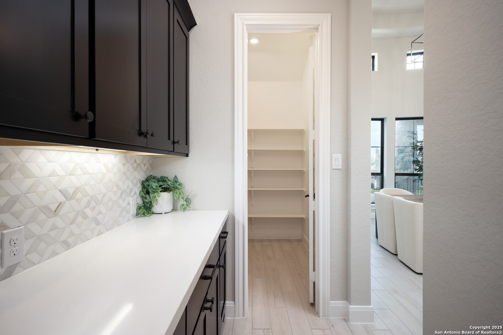 431 Falcon Cove Castroville, TX 78009 - Photo 30 of 46 a view of hallway with cabinets and wooden floor