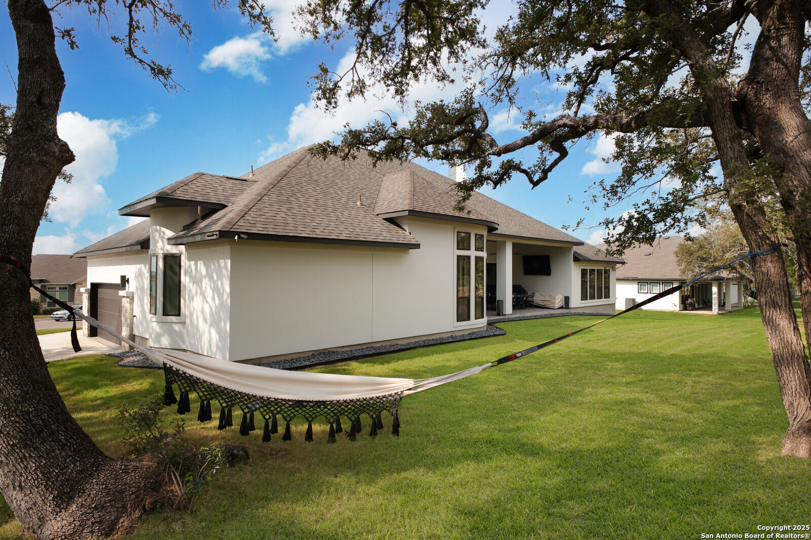 431 Falcon Cove Castroville, TX 78009 - Photo 35 of 46 a view of a house with backyard and a tree