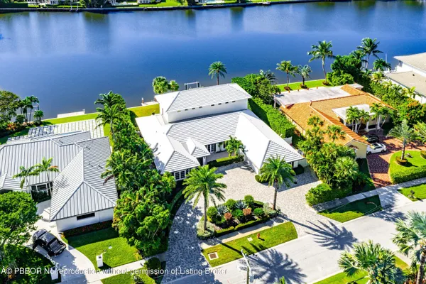 an aerial view of a house with a yard basket ball court and outdoor seating