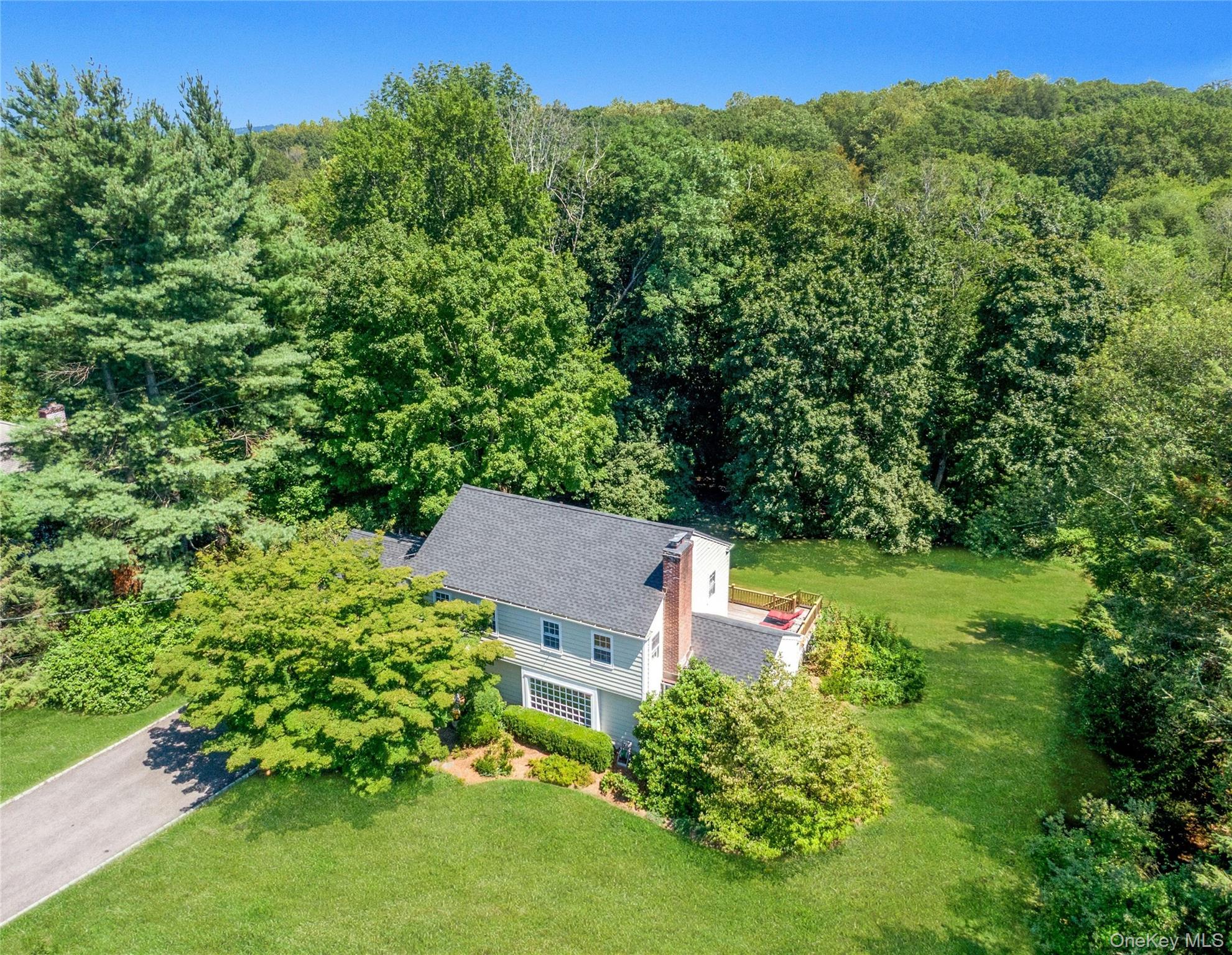 an aerial view of a house with yard swimming pool and outdoor seating