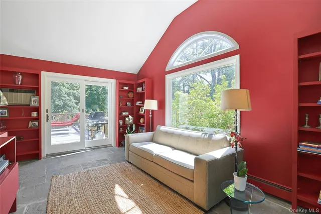 a living room with a large window and a table