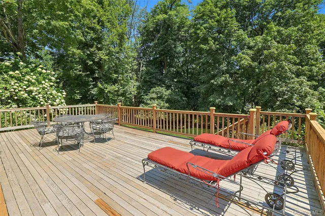 a balcony with wooden floor and furniture