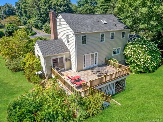 a aerial view of a house with swimming pool table and chairs