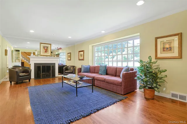 a living room with furniture fireplace and window