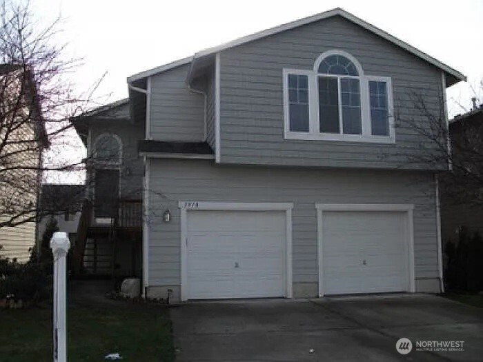 a front view of a house with parking
