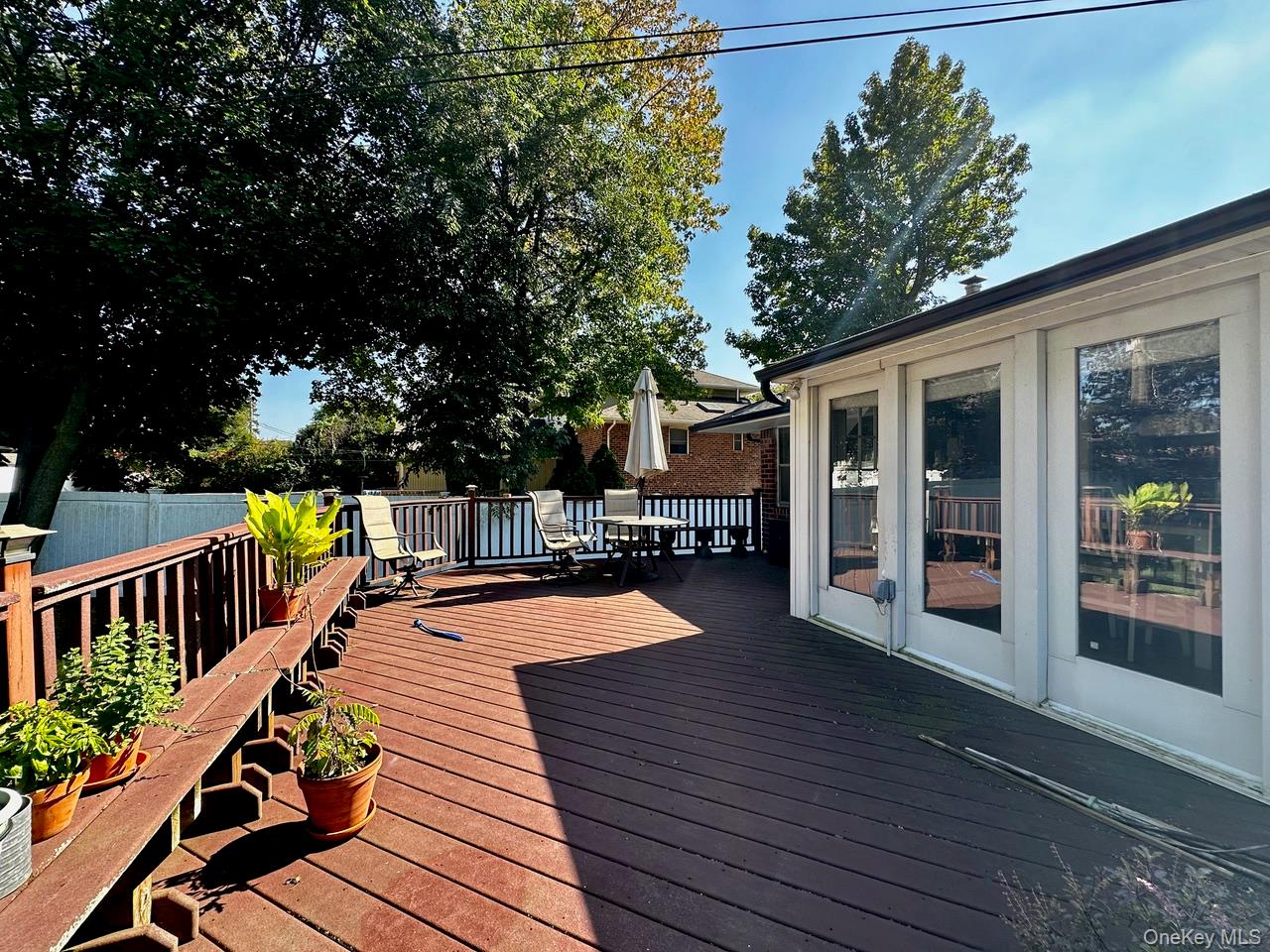 26 Canterbury Road Woodbury, NY 11797 - Photo 15 of 17 a view of a house with wooden deck