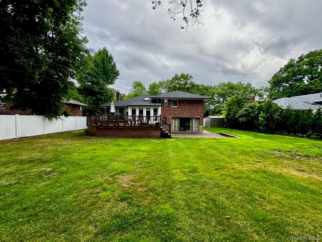 26 Canterbury Road Woodbury, NY 11797 - Photo 17 of 17 a view of a house with a backyard