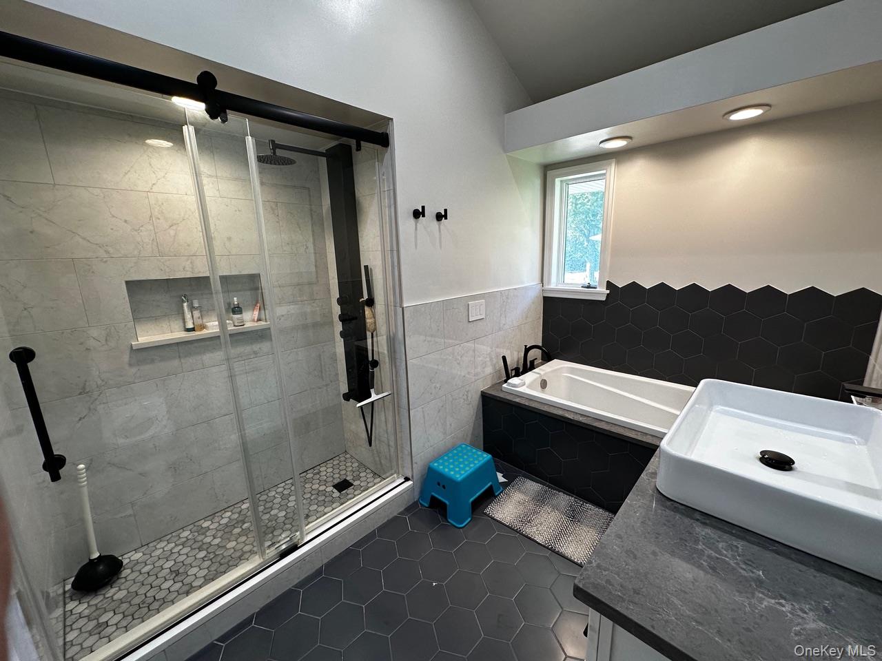 26 Canterbury Road Woodbury, NY 11797 - Photo 7 of 17 a bathroom with a tub and a shower