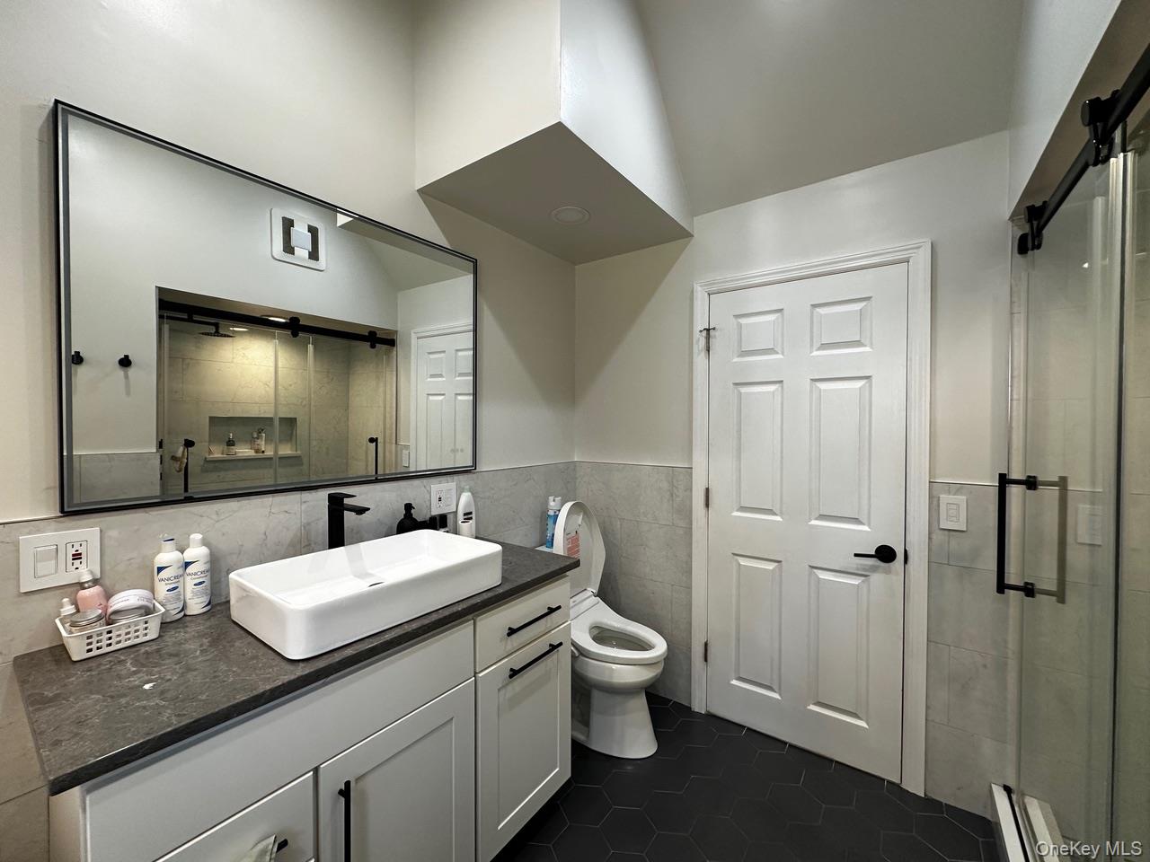 26 Canterbury Road Woodbury, NY 11797 - Photo 8 of 17 a bathroom with a granite countertop sink and a mirror