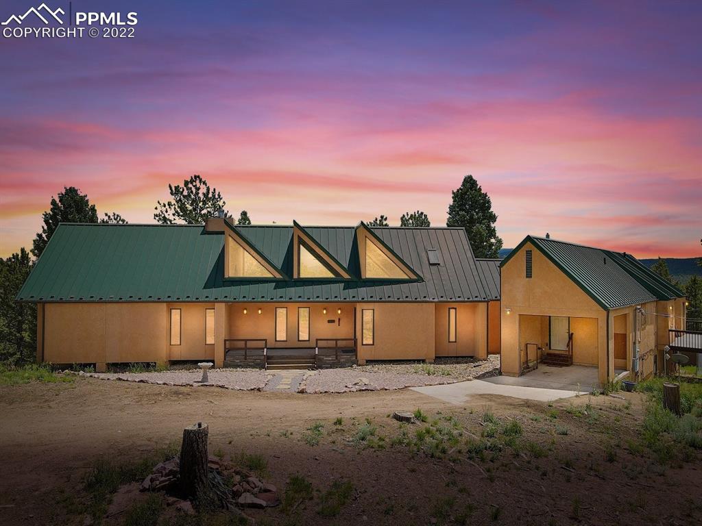 6900 Highway 24 Divide, CO 80814 - Photo 50 of 50 a front view of a house with a yard and garage