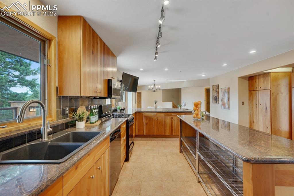 6900 Highway 24 Divide, CO 80814 - Photo 5 of 50 a kitchen with stainless steel appliances a sink a stove top oven a counter space and cabinets