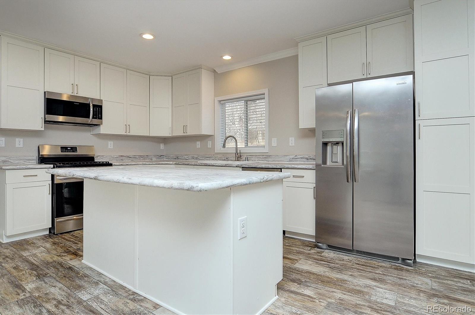 16554 Rocky Mountain Road Salida, CO 81201 - Photo 9 of 33 a kitchen with stainless steel appliances granite countertop a refrigerator sink and microwave