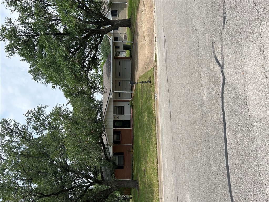 Ranch-style house with a garage, driveway, and a f