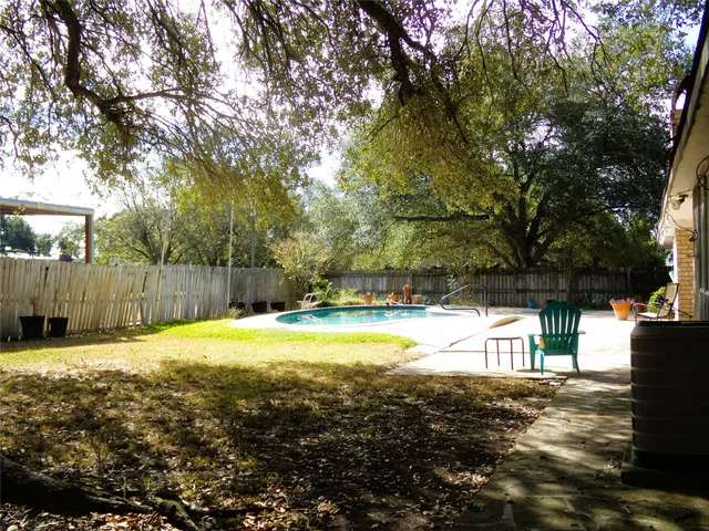 a view of a backyard with swimming pool