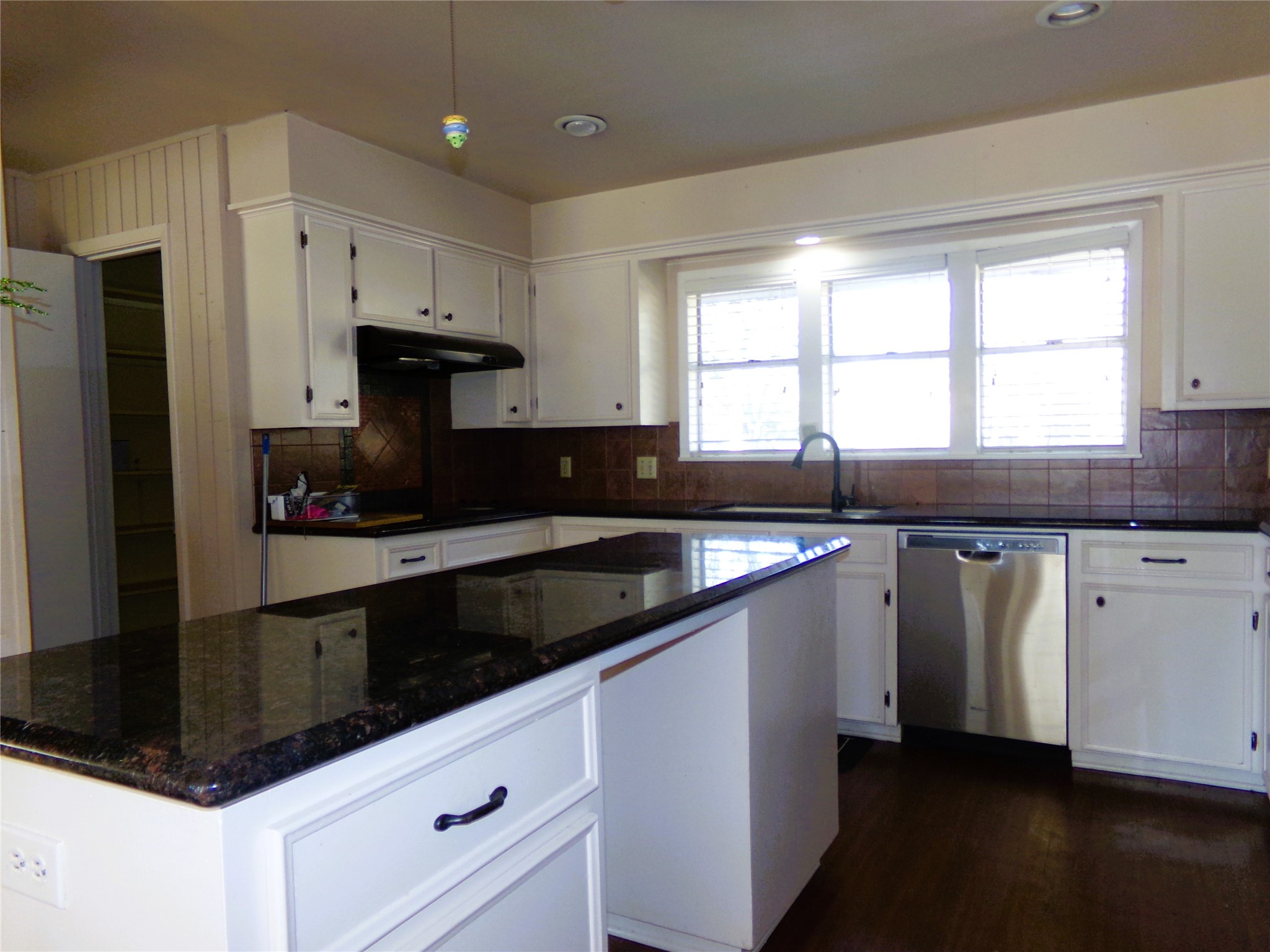 605 South Summit Street Weimar, TX 78962 - Photo 3 of 24 a kitchen with granite countertop a sink and a stove top oven