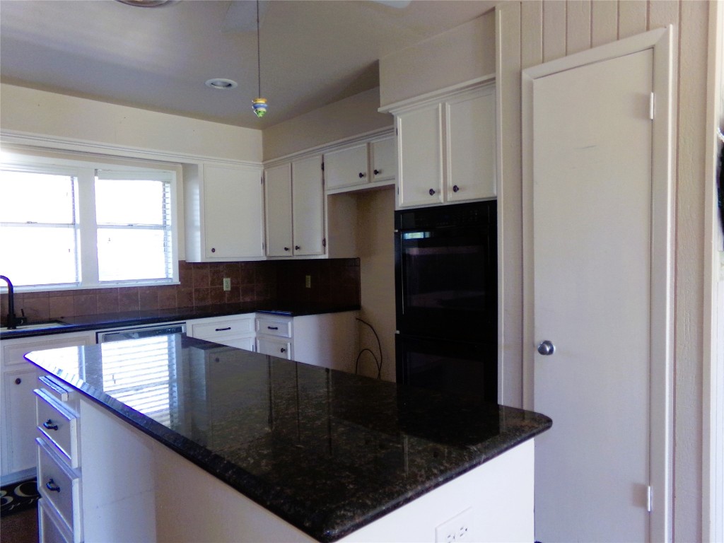 605 South Summit Street Weimar, TX 78962 - Photo 4 of 24 a kitchen with a sink and cabinets
