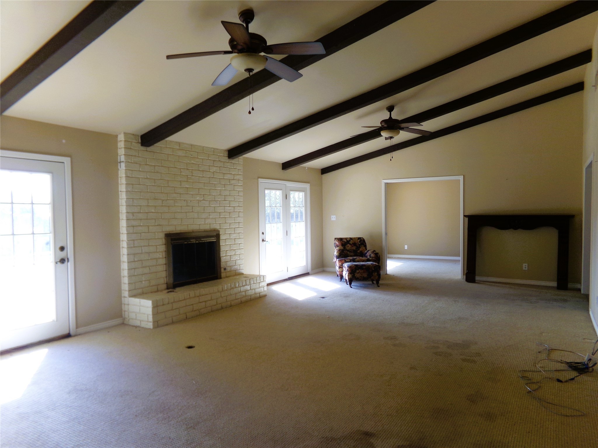 605 South Summit Street Weimar, TX 78962 - Photo 6 of 24 a view of empty room with fireplace and fan