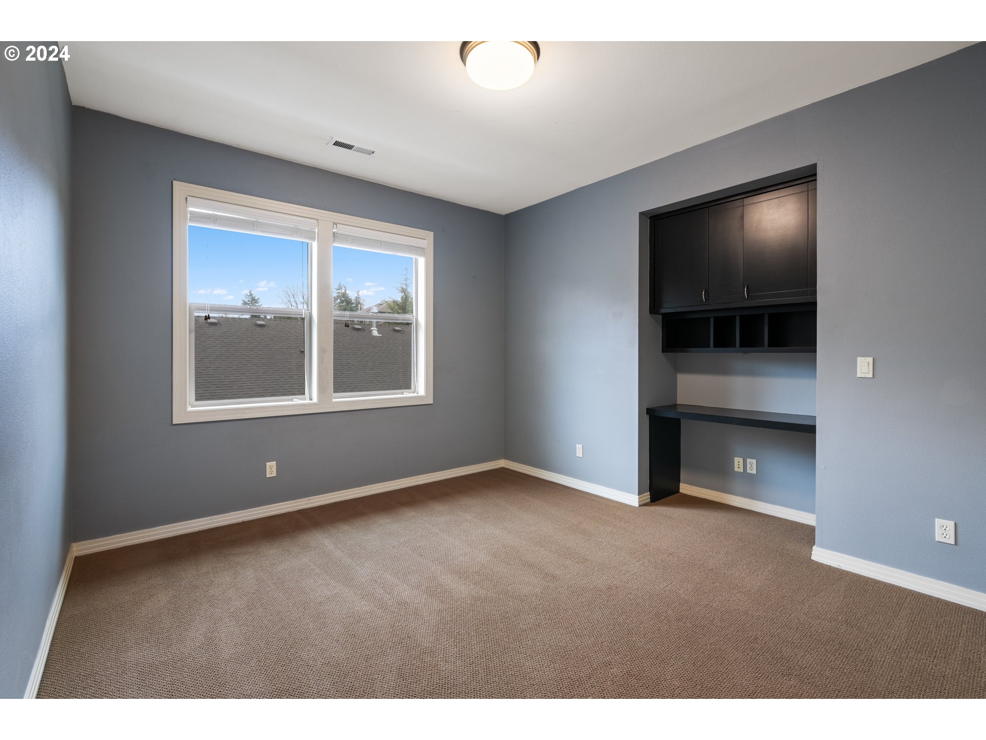 2401 South 17th Way Ridgefield, WA 98642 - Photo 36 of 46 a view of an empty room with a window and wooden floor