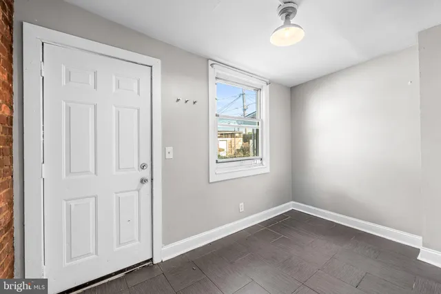 an empty room with windows and closet