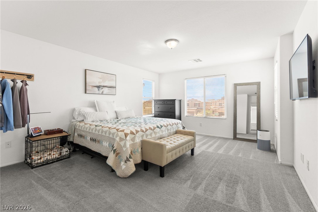 6435 Point Isabel Way Las Vegas, NV 89122 - Photo 3 of 57 A quiet retreat with plush carpet flooring, illuminated by natural light through large windows.