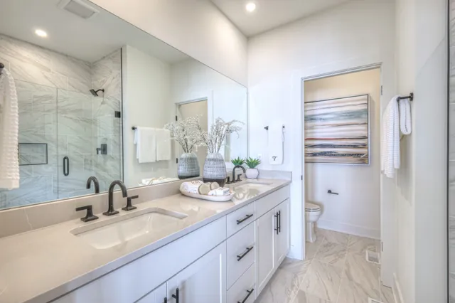 a bathroom with a double vanity sink mirror and double