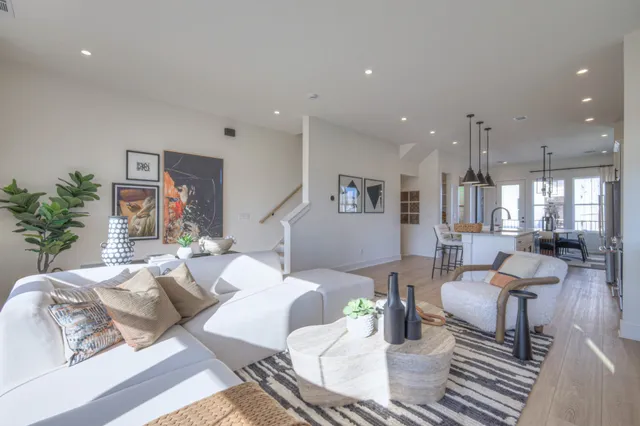 a living room with fireplace furniture and a potted plant