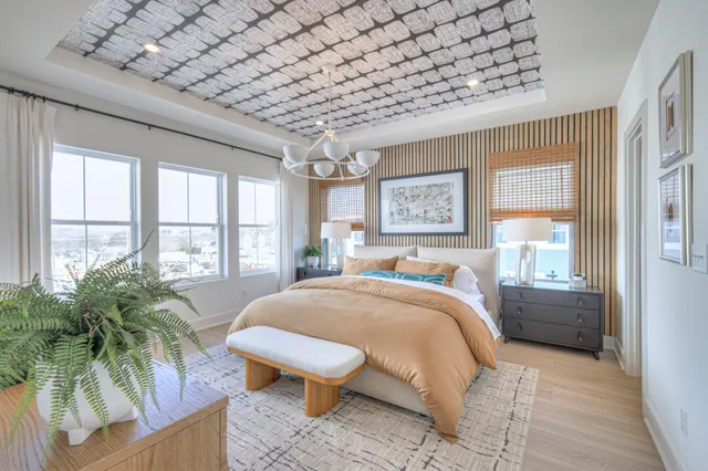 a bed room with a bed and a large window