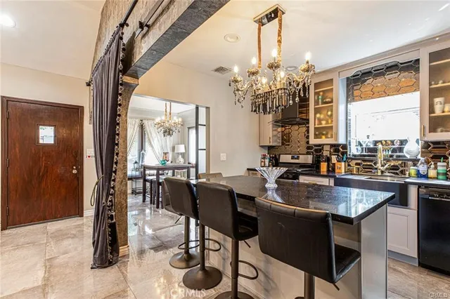 a dining table with chairs and chandelier