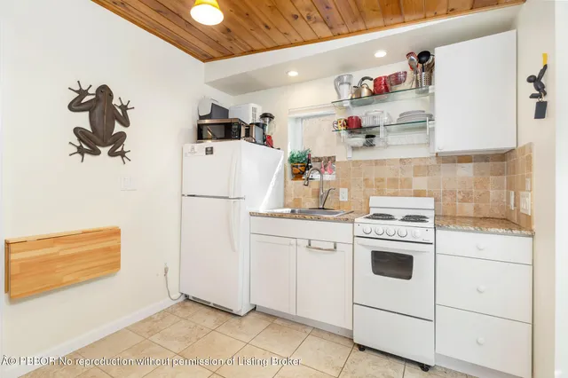a kitchen with refrigerator and cabinets